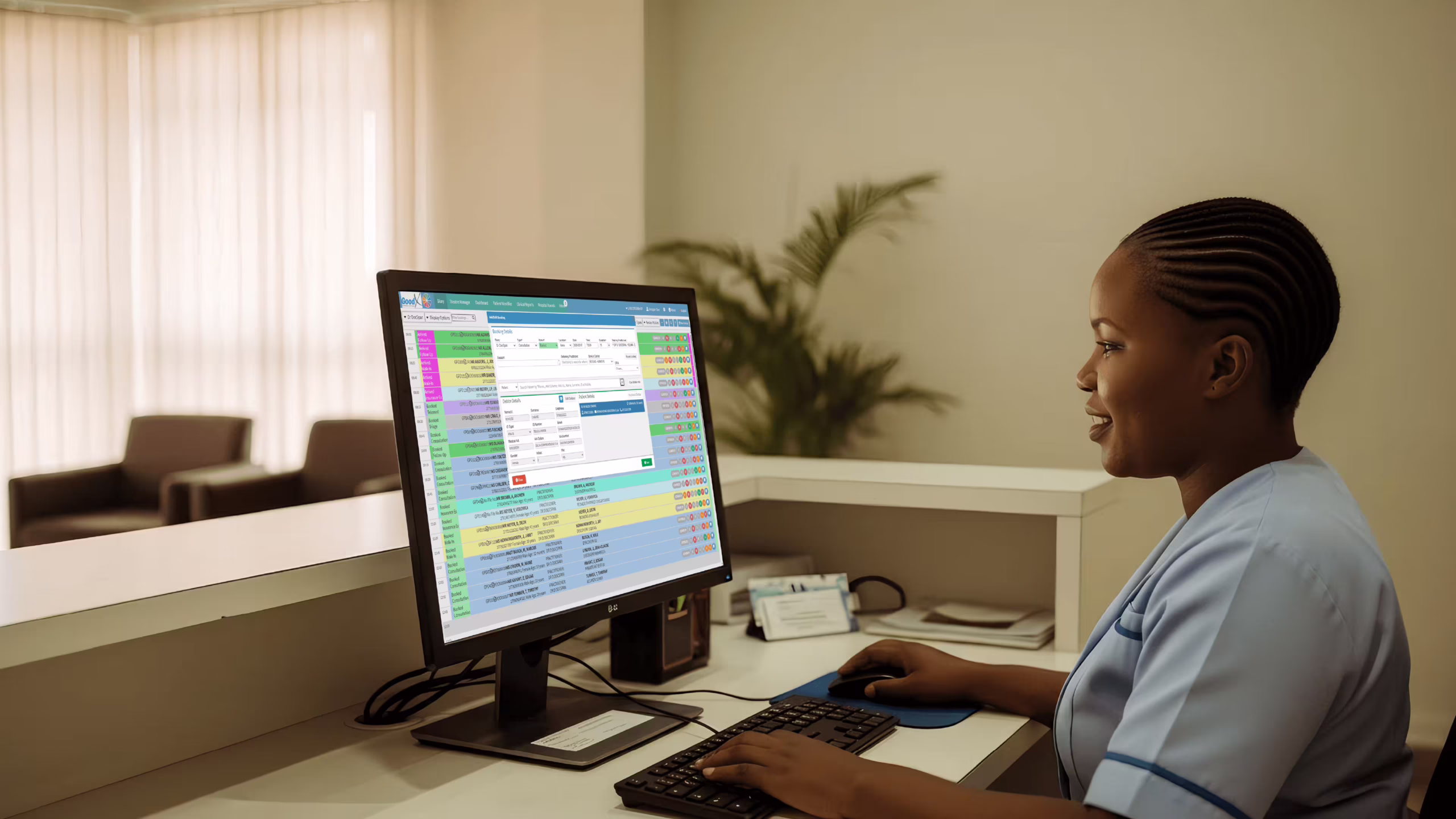 healthcare-scheduling-software-goodx Receptionist using healthcare scheduling software to manage patient appointments in a Botswana clinic