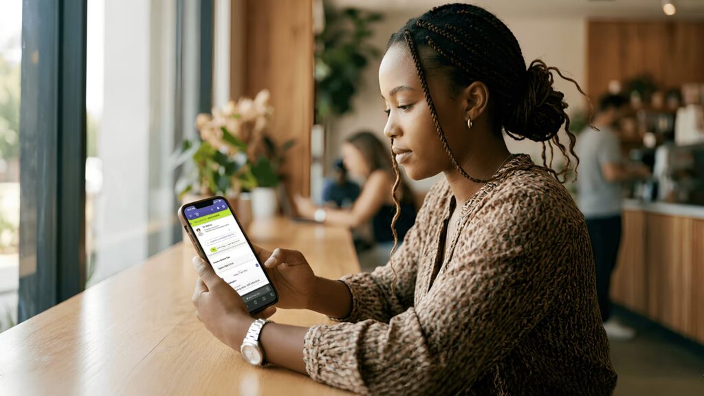 Patient using patient scheduling software on a smartphone to book a medical appointment at a Botswana clinic